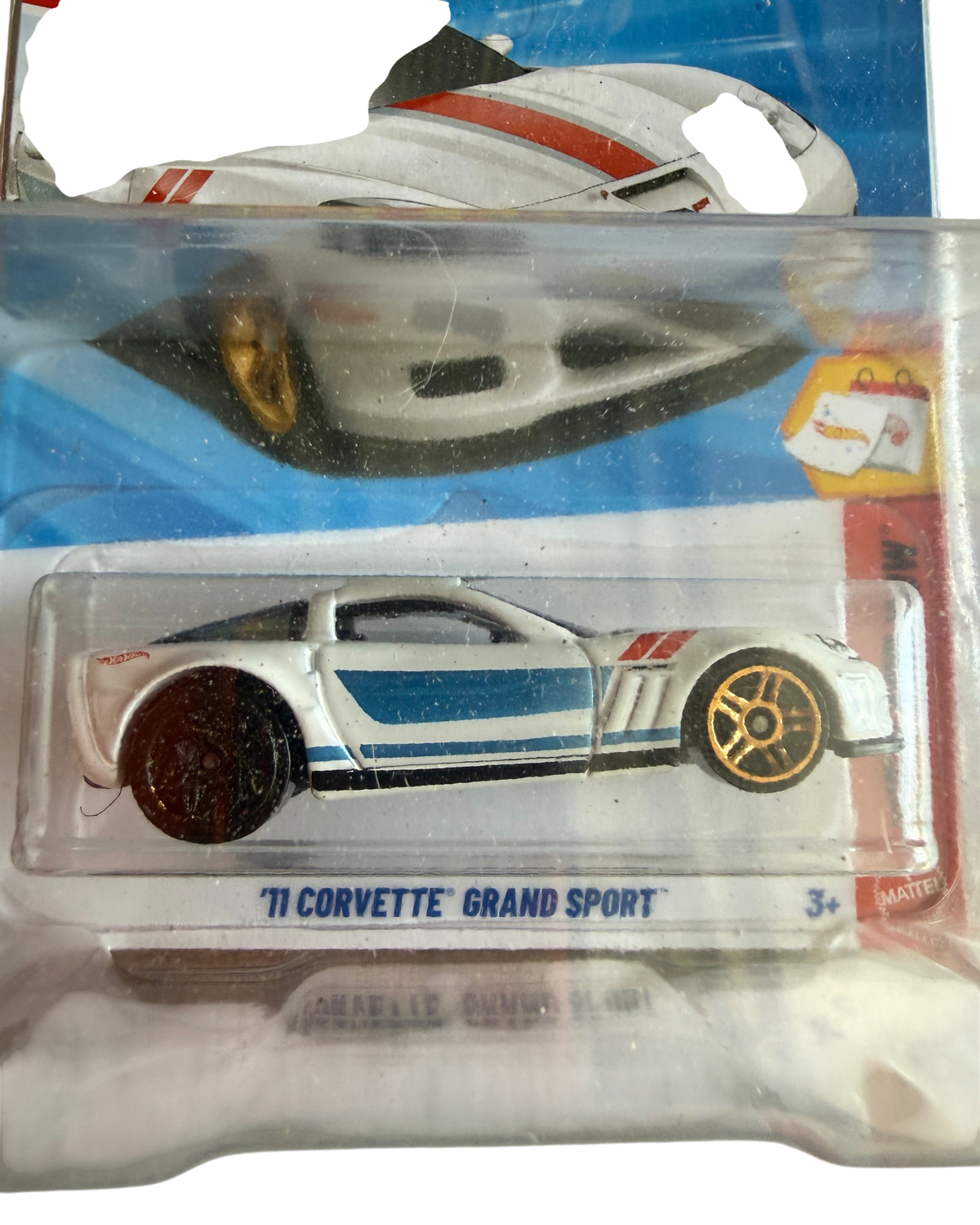 More Than Diecast Hot Wheels 11 Corvette Grand Sport die-cast car in white with blue stripes on an error card