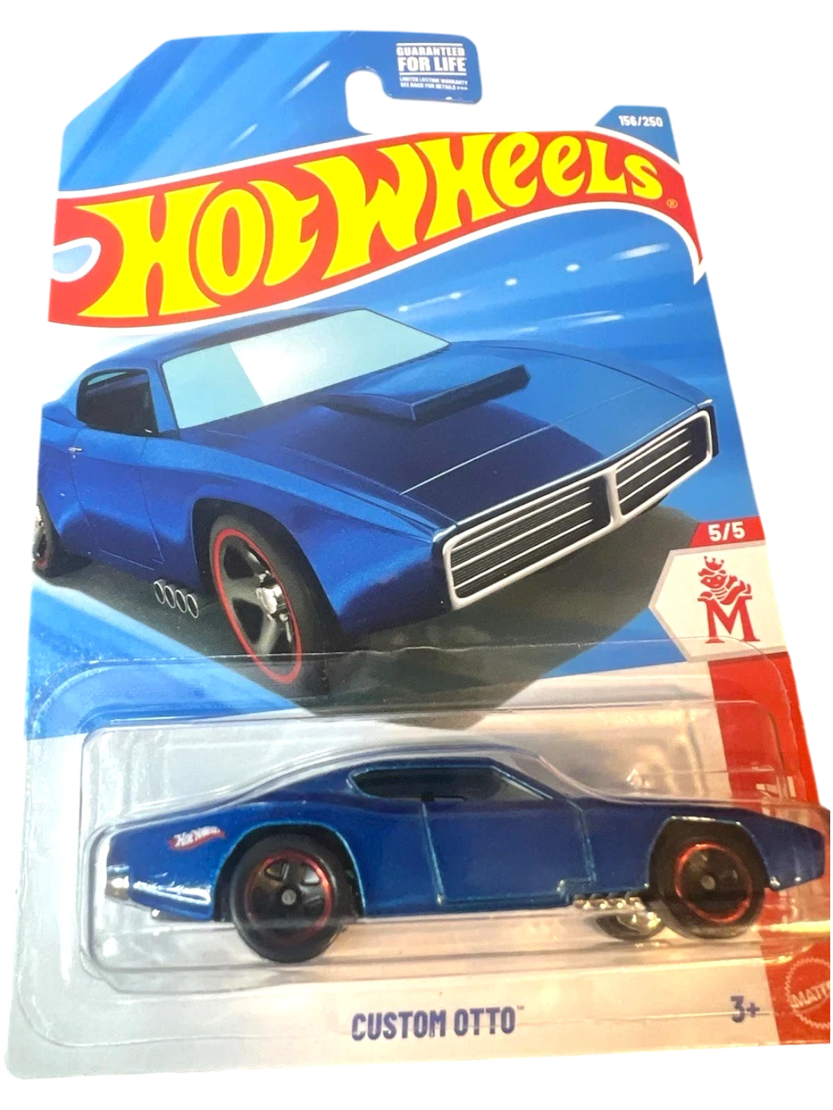 More Than Diecast Custom Otto blue die-cast toy car with red rim accents on a Hot Wheels card.