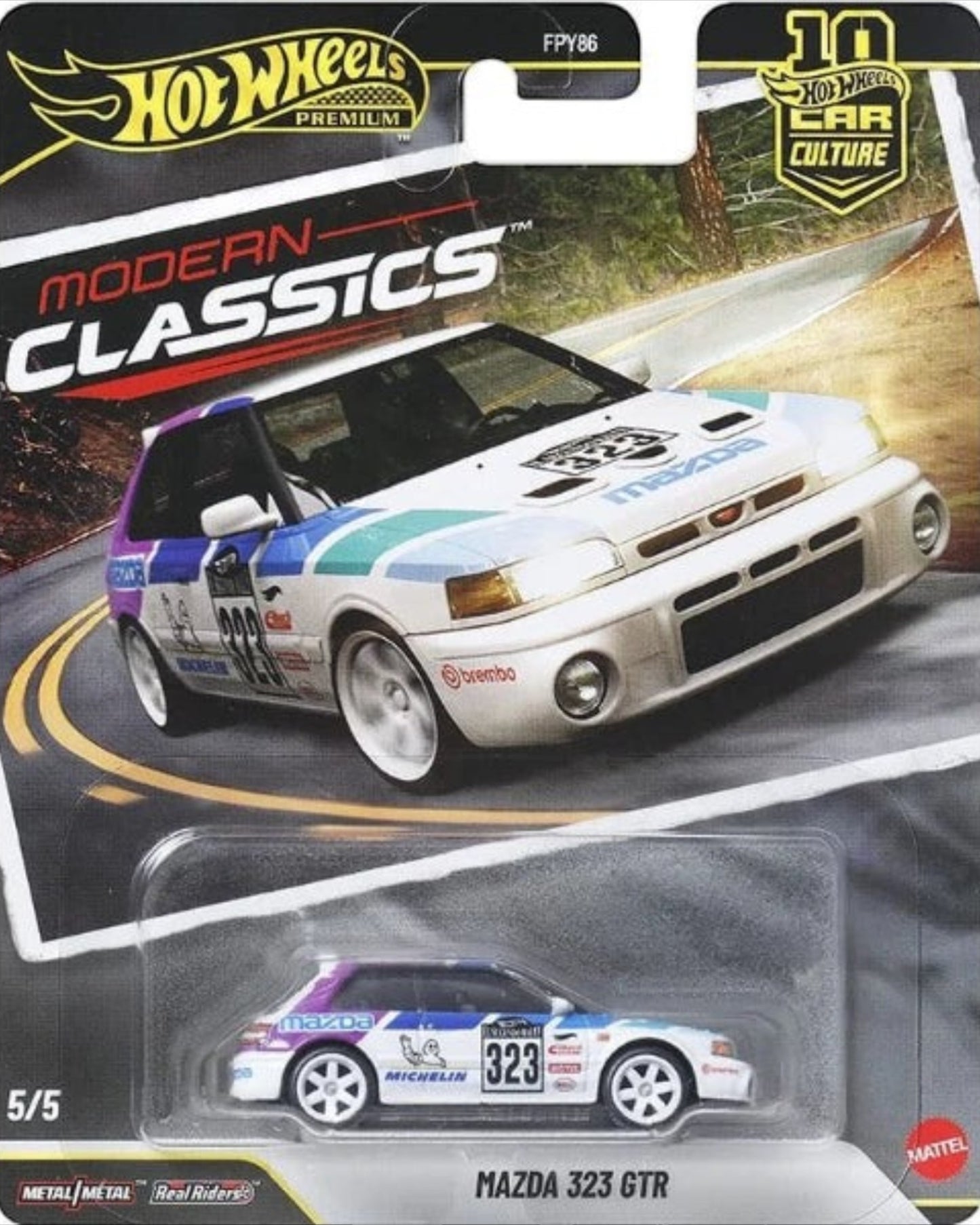 More Than Diecast Hot Wheels Premium Modern Classics Mazda 323 GTR 1:64 scale die-cast car with white, blue, and purple racing livery.