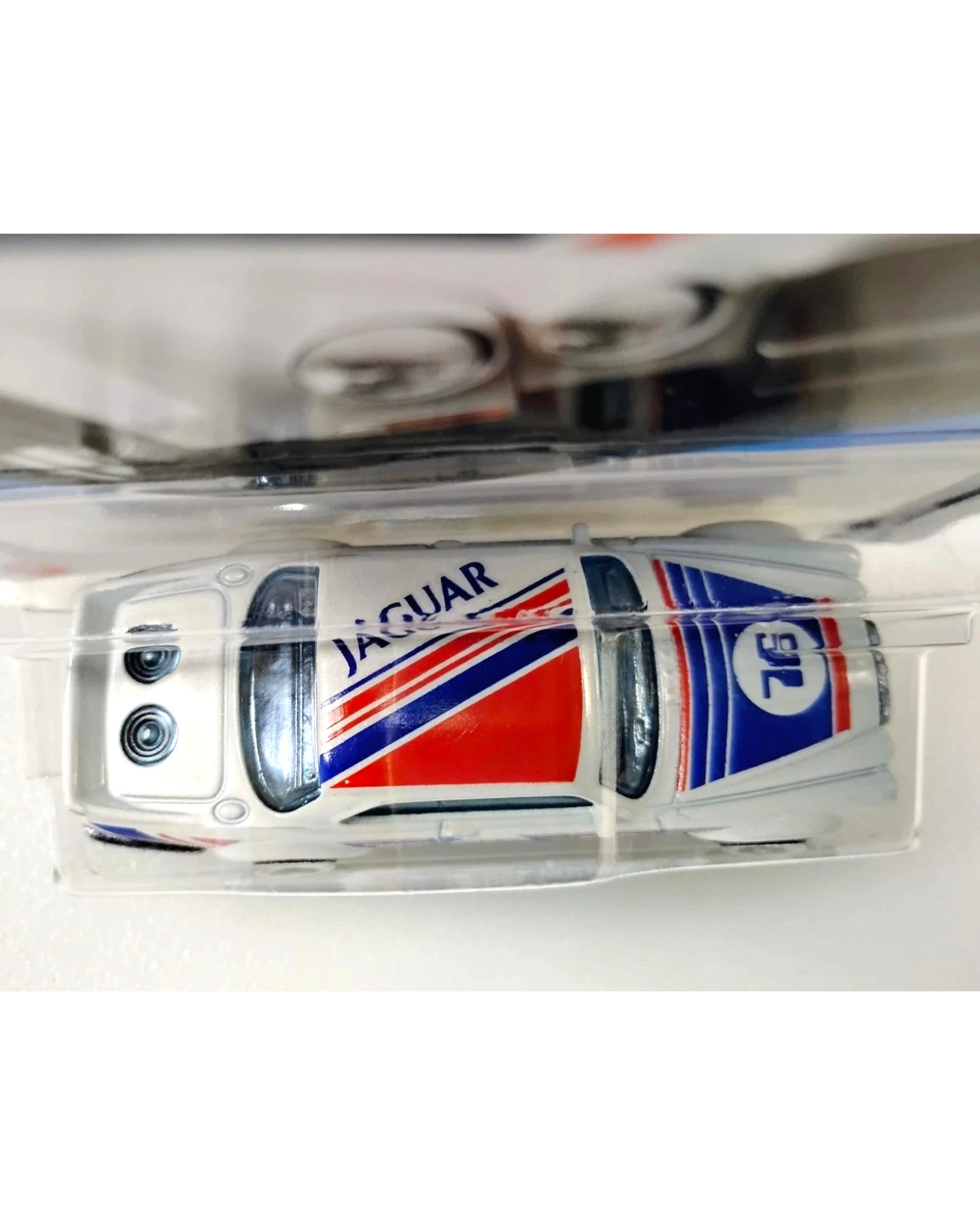 More Than Diecast 2025 Hot Wheels Jaguar XJC V12 Coupe in white with red and blue racing stripes and number 76 decal