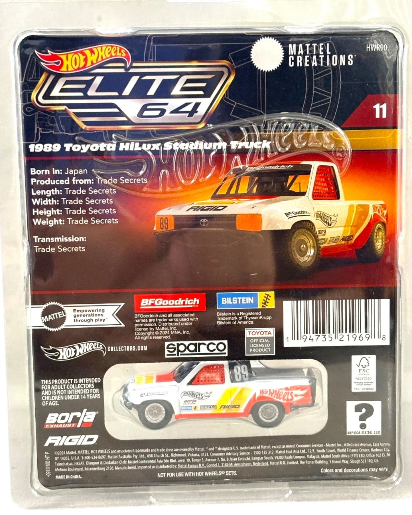 More Than Diecast: Hot Wheels Elite 64 1989 Toyota Hilux Stadium Truck, white with red and yellow racing stripes, die-cast collectible.