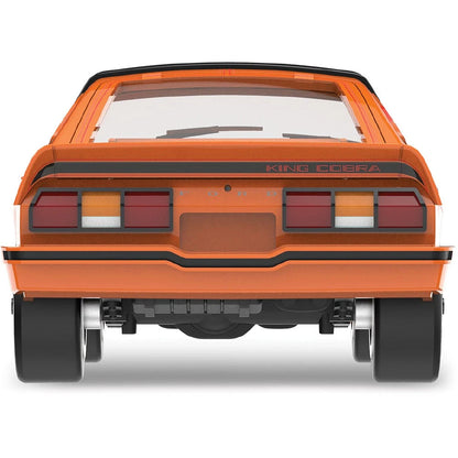 More Than Diecast 1978 Ford Mustang King Cobra II model car in tangerine and black, rear view showing spoiler detail.