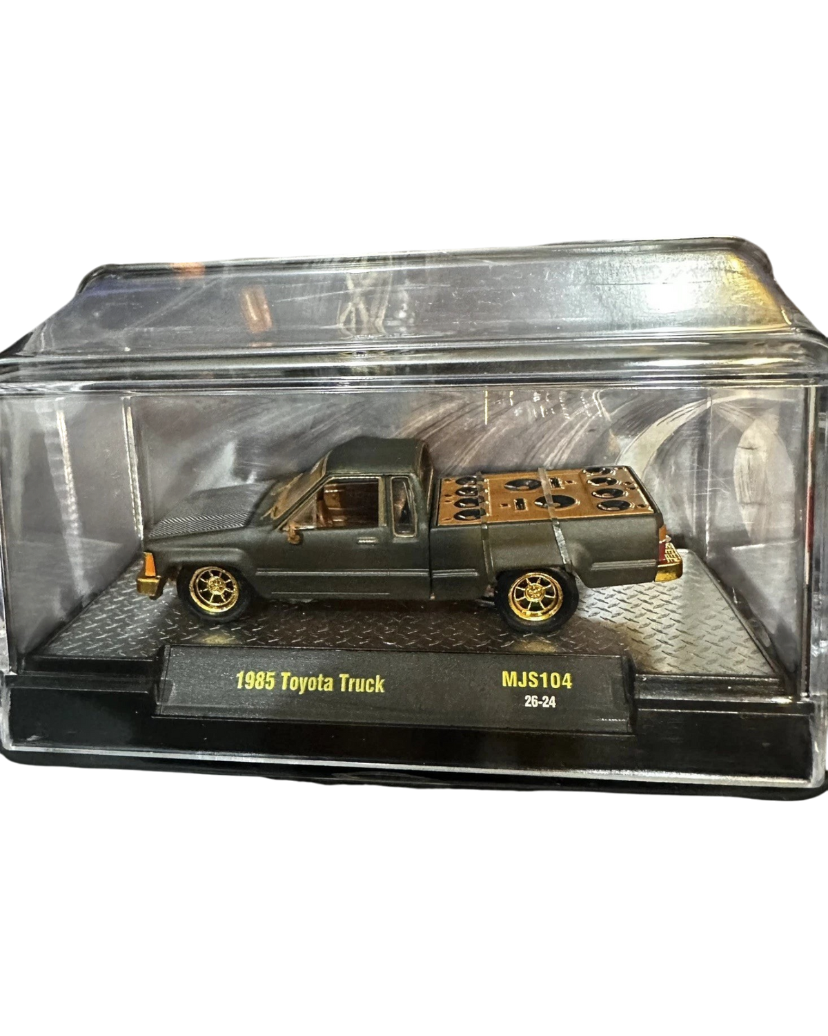 More Than Diecast 1:64 scale matte grey 1985 Toyota pickup truck chase variant with gold wheels in display case