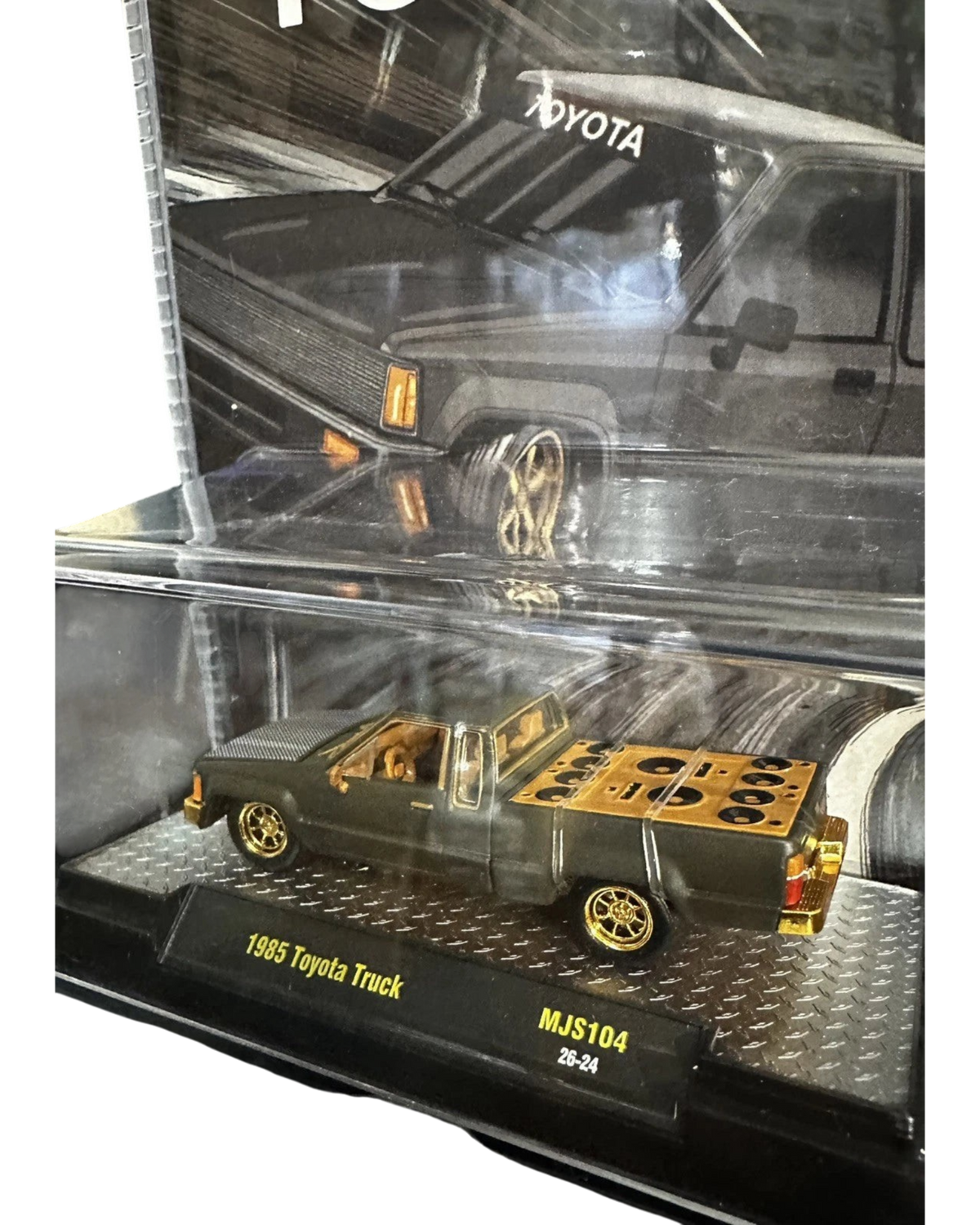 More Than Diecast 1985 Toyota Pickup Truck chase variant in matte grey with gold wheels and custom bed detail