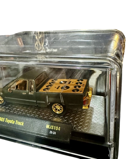 More Than Diecast M2 Machines 1985 Toyota Pickup Truck chase variant in matte grey with gold bed detail in display case