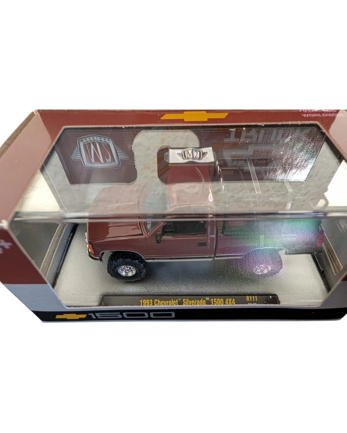More Than Diecast 1:64 scale 1993 Chevrolet Silverado 1500 4x4 die-cast truck in a maroon finish inside display box