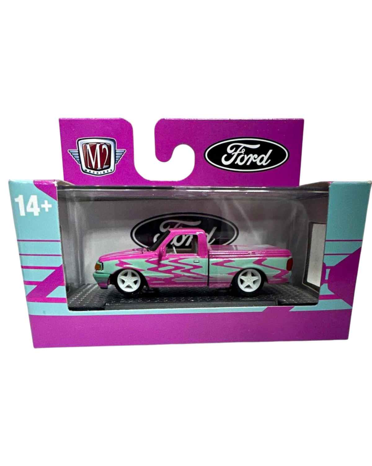 More Than Diecast 1:64 scale 1995 Ford Ranger in pink and blue two-tone livery with custom flame graphics in packaging