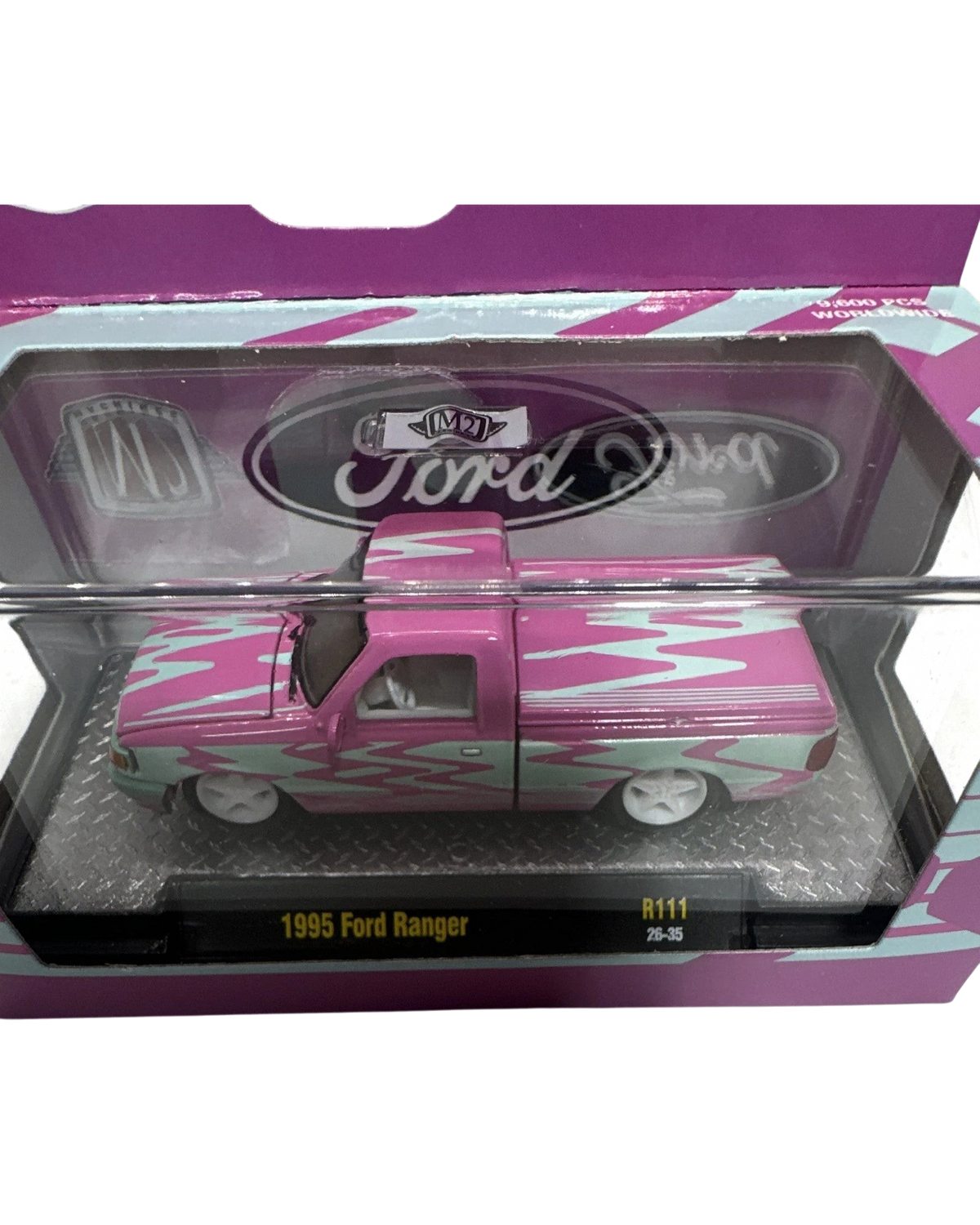 More Than Diecast 1:64 scale 1995 Ford Ranger in a pink and blue two-tone flame livery inside its display packaging.