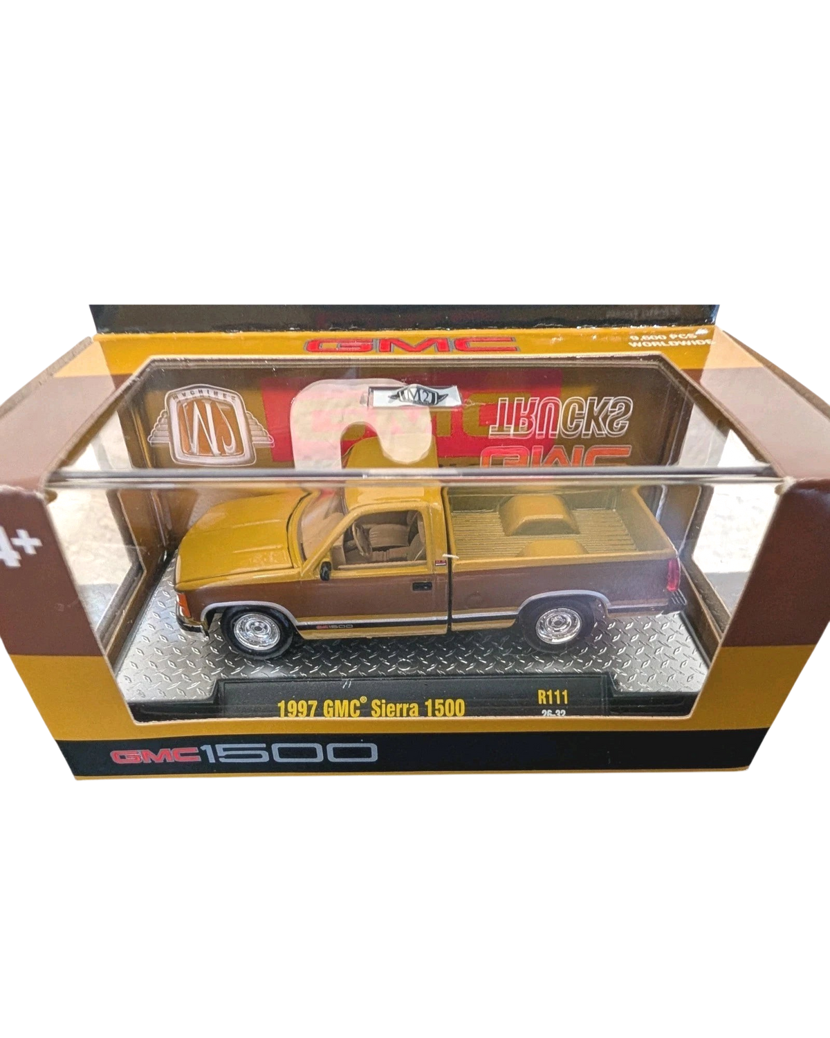 More Than Diecast 1:64 scale 1997 GMC Sierra 1500 die-cast truck in two-tone brown and tan inside display packaging.