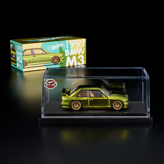 More Than Diecast Hot Wheels RLC 1991 BMW M3 in spectraflame olive with gold wheels inside an acrylic display case.