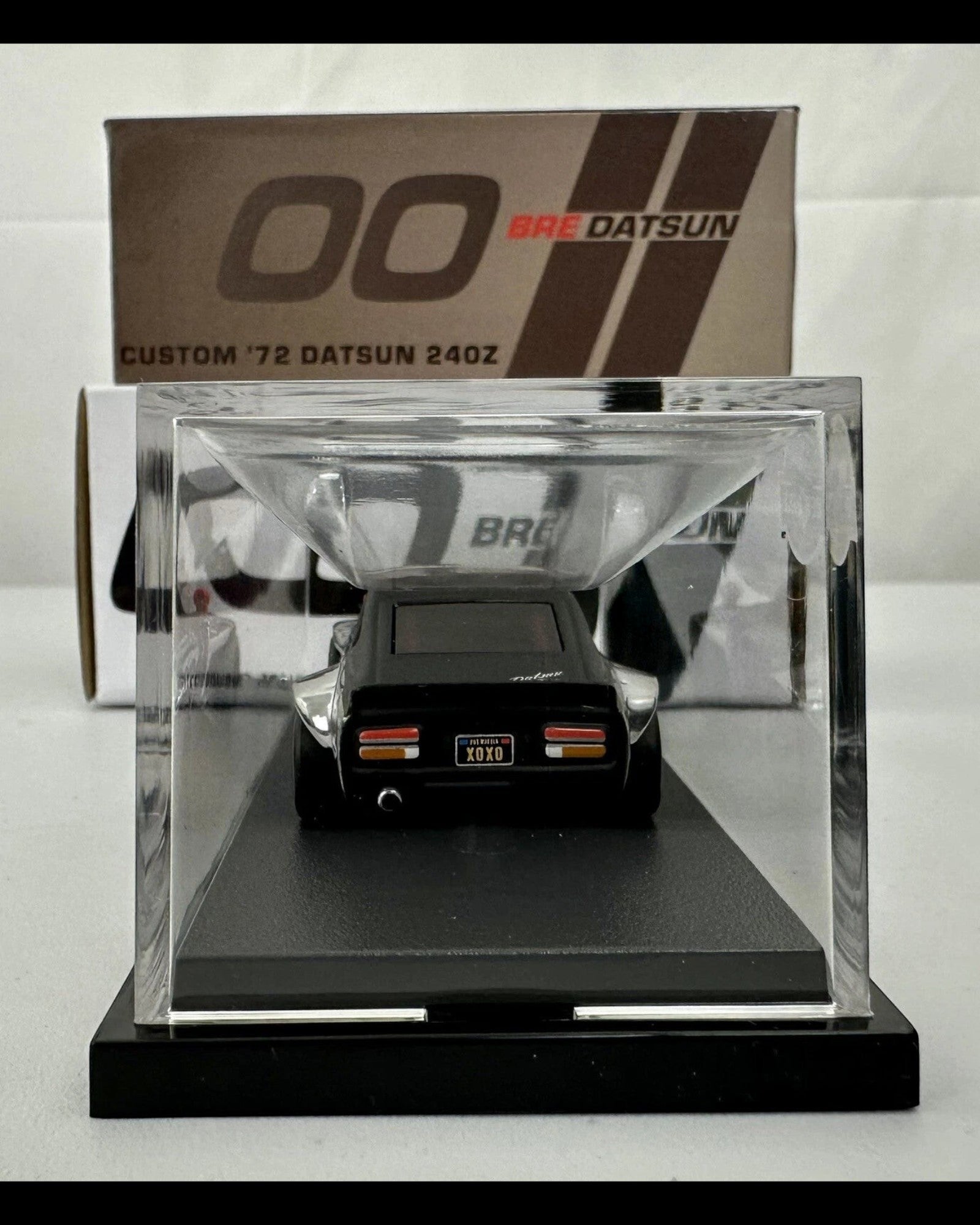 More Than Diecast Hot Wheels RLC Custom 72 BRE Datsun 240Z in a clear display case, rear view showing XOXO license plate