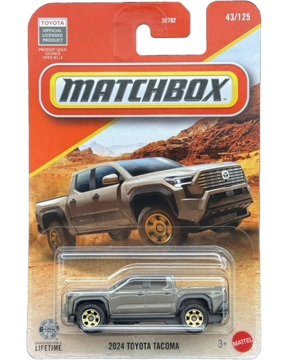 More Than Diecast 1:64 scale brown 2024 Toyota Tacoma die-cast truck in original Matchbox blister card packaging