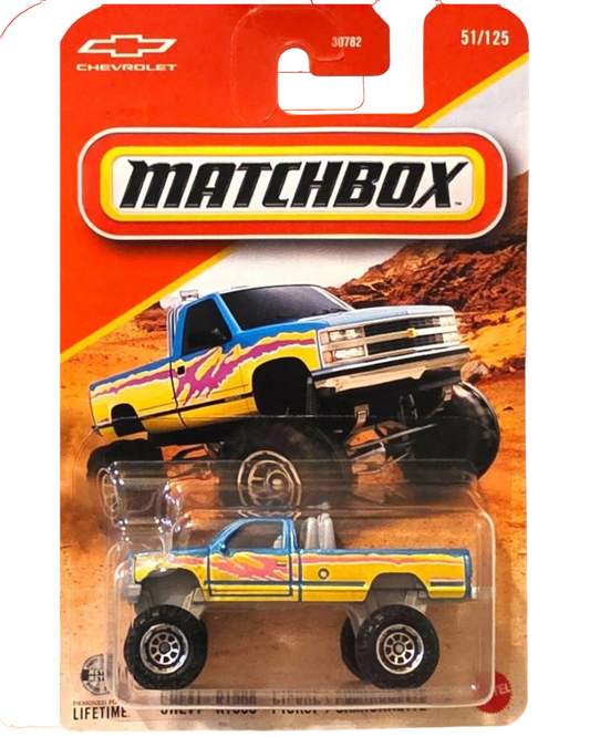 More Than Diecast Matchbox 2026 Chevy K1500 pickup truck in 1:64 scale with blue and yellow custom paint job.