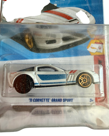 More Than Diecast Hot Wheels 11 Corvette Grand Sport die-cast car in white with blue stripes on an error card