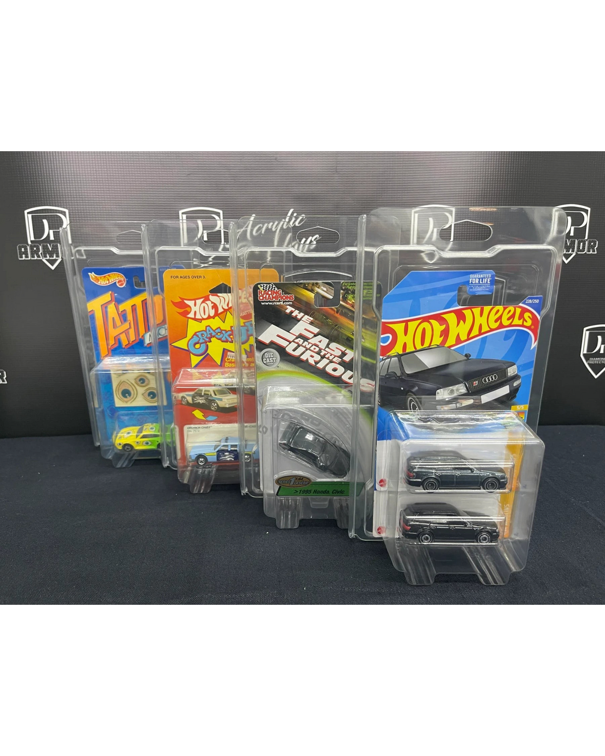 More Than Diecast Diamond dual-card protectors displaying various Hot Wheels and diecast cars in clear PVC cases.