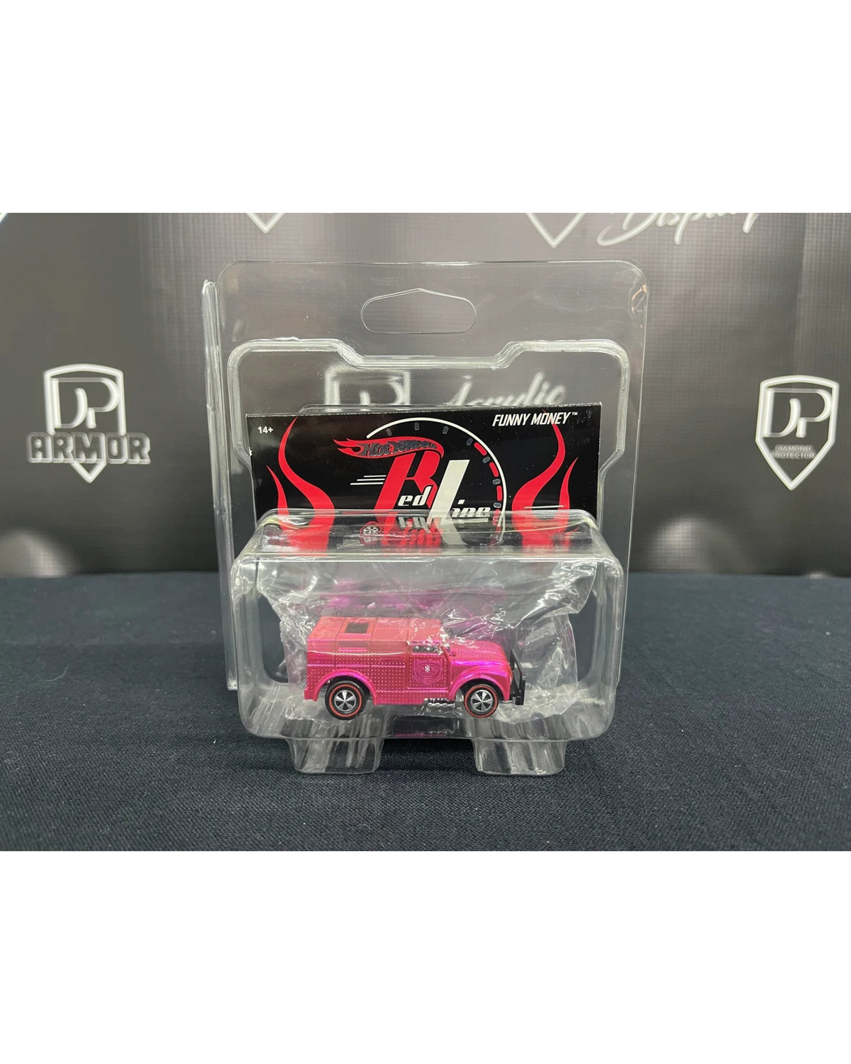 More Than Diecast Diamond Short Card Protector holding a pink Hot Wheels Funny Money diecast car in clear PVC casing.