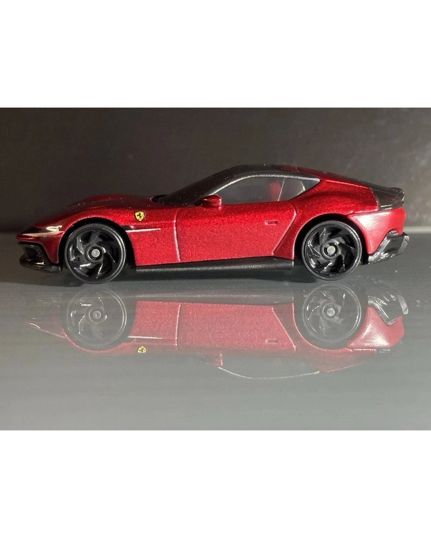 More Than Diecast Hot Wheels Ferrari 12 Cilindri in metallic red, 1:64 scale die-cast model with black wheels.