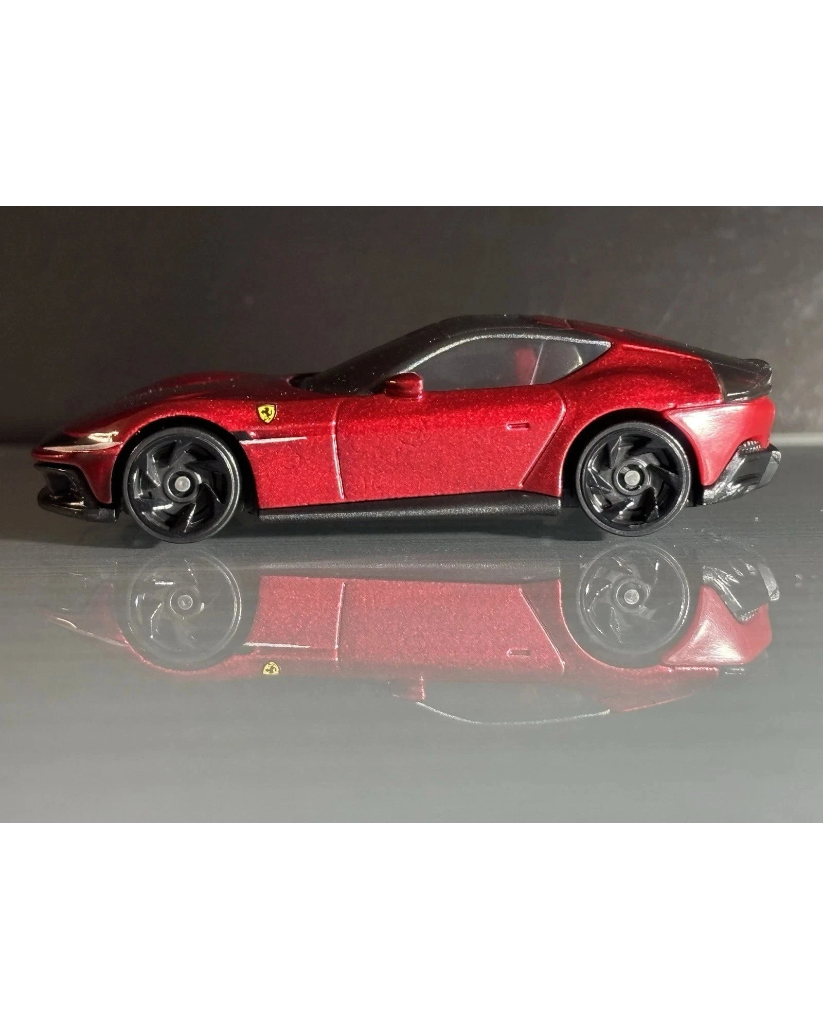 More Than Diecast Hot Wheels Ferrari 12 Cilindri in metallic red, 1:64 scale die-cast model with black wheels.