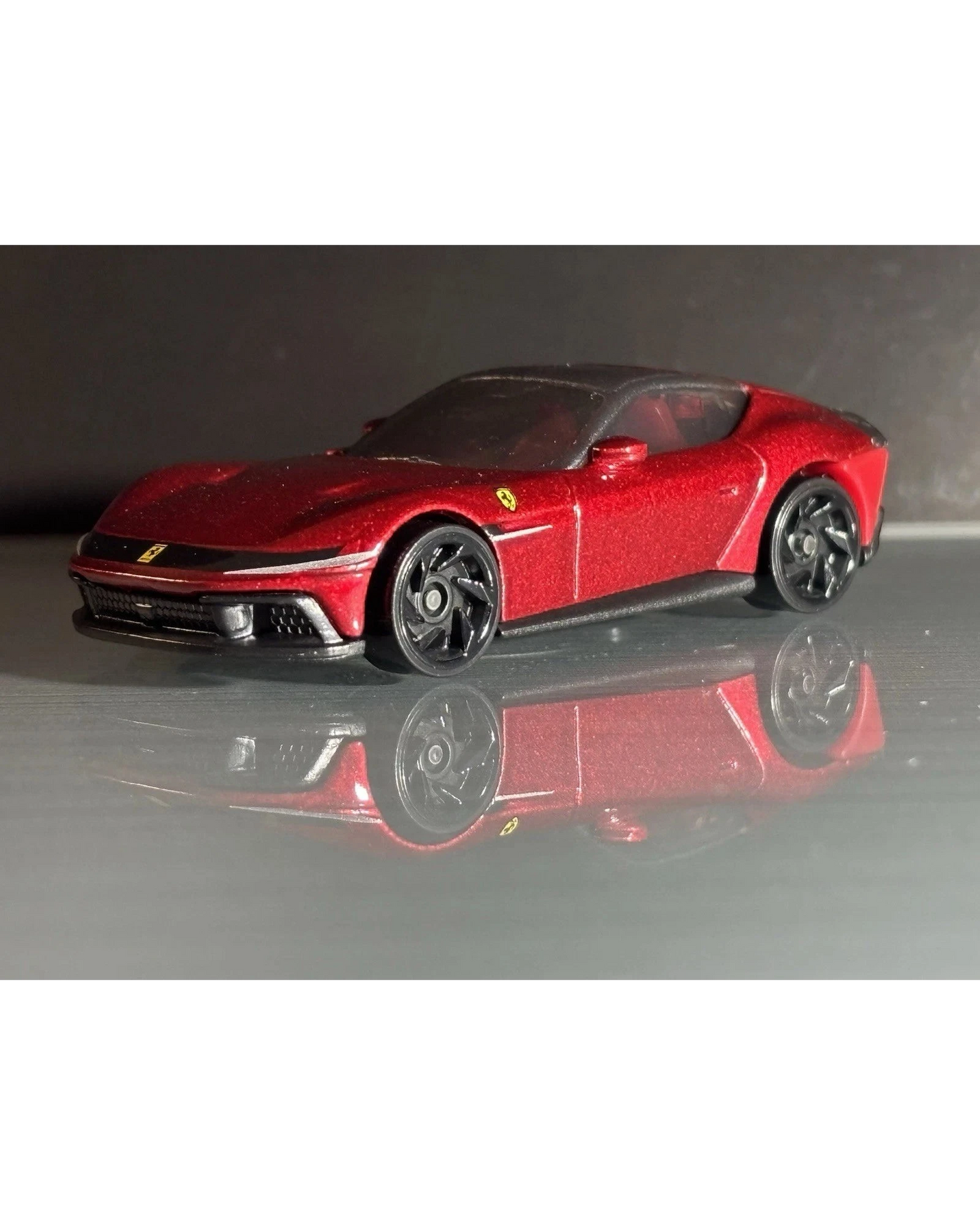 More Than Diecast Hot Wheels Ferrari 12 Cilindri in metallic red with black wheels, 1:64 scale die-cast model car.