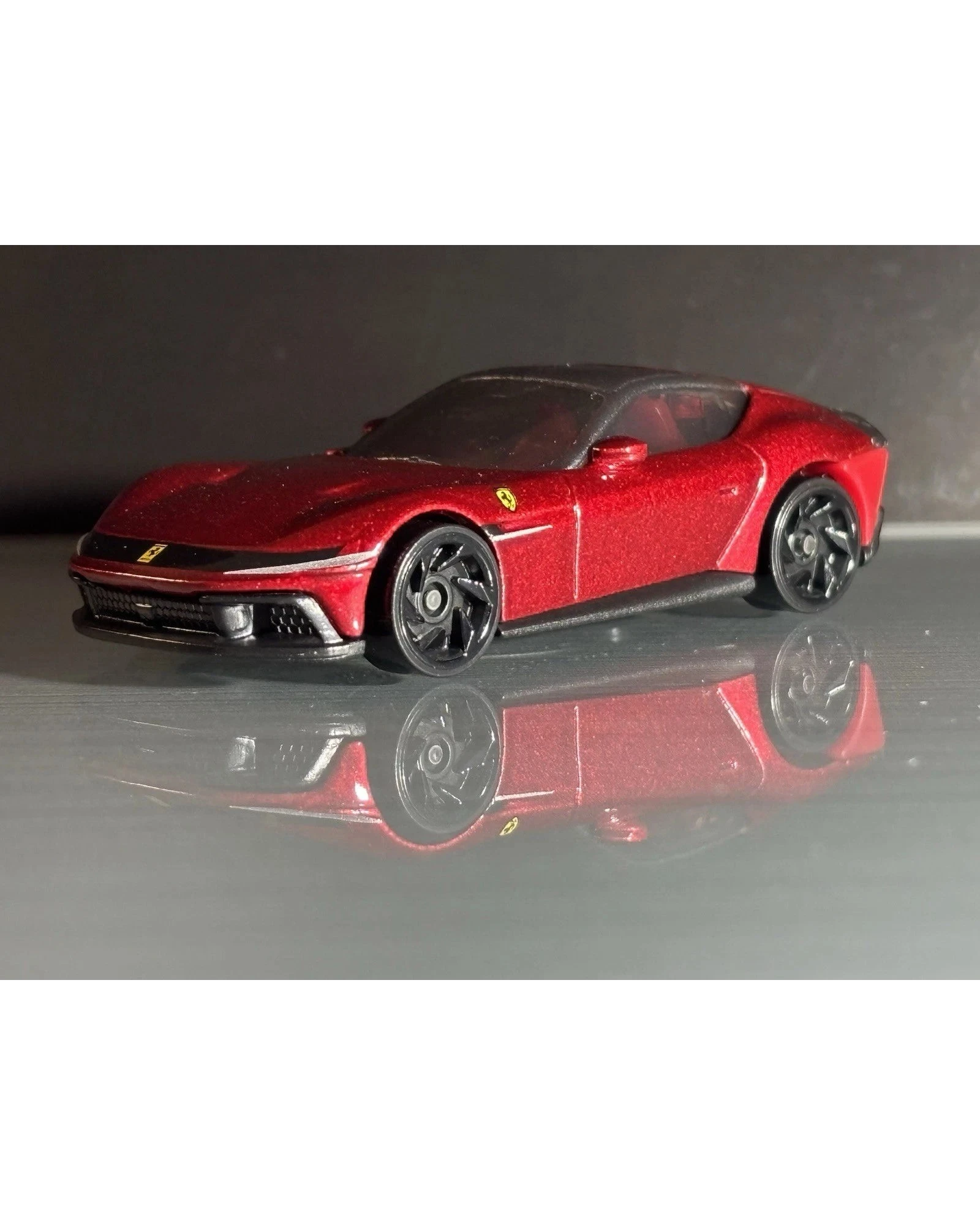 More Than Diecast Hot Wheels Ferrari 12 Cilindri in metallic red with black wheels, 1:64 scale die-cast model car.