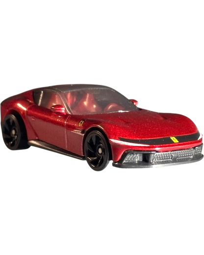 More Than Diecast Hot Wheels Ferrari 12 Cilindri 1:64 scale die-cast car in metallic red with black wheels.