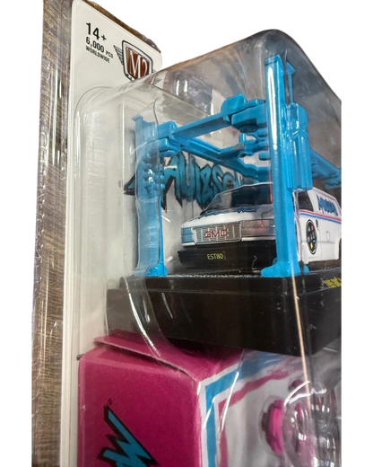 More Than Diecast M2 Machines 1995 GMC Safari Van in white with Maui and Sons graphics in blister pack with blue lift