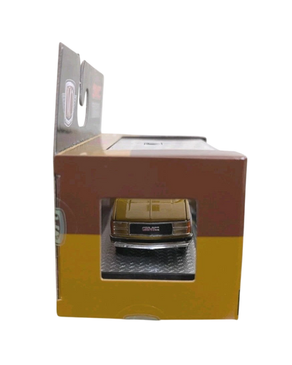 More Than Diecast 1:64 scale 1997 GMC Sierra 1500 die-cast truck in two-tone brown and tan inside its display box