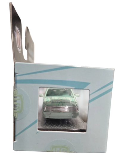 More Than Diecast 1:64 scale 1995 Chevrolet S10 lowrider in green, viewed through the front of its display box.