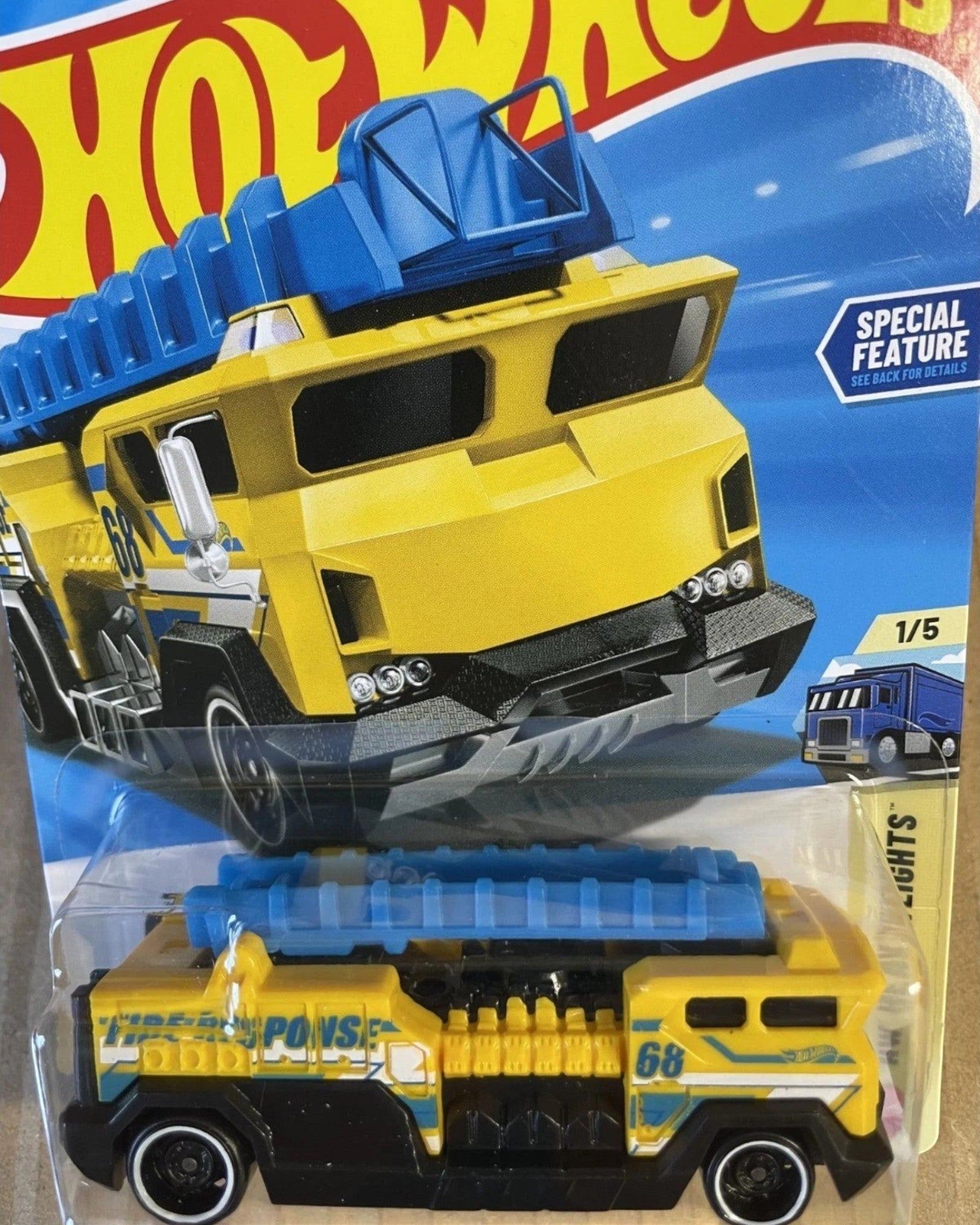 More Than Diecast Hot Wheels 5 Alarm fire truck toy in yellow and blue, HW Heavyweights series in original packaging.