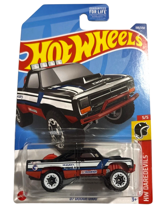 More Than Diecast 2023 Hot Wheels Treasure Hunt '87 Dodge D100 pickup truck, black with red, white, and blue racing stripes.
