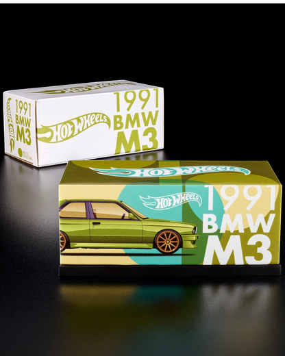 More Than Diecast Hot Wheels RLC 1991 BMW M3 in olive green with gold wheels, displayed in its branded acrylic case.
