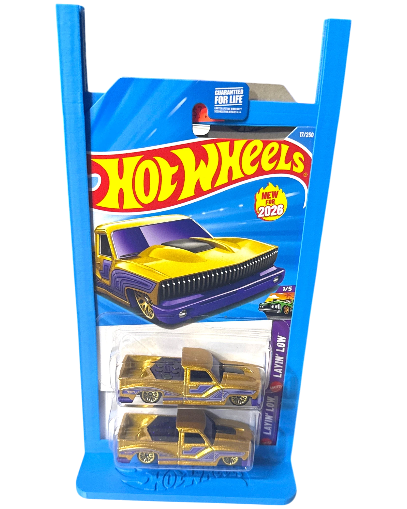 More Than Diecast blue 3-D printed display stand holding two gold Hot Wheels Layin' Low trucks.