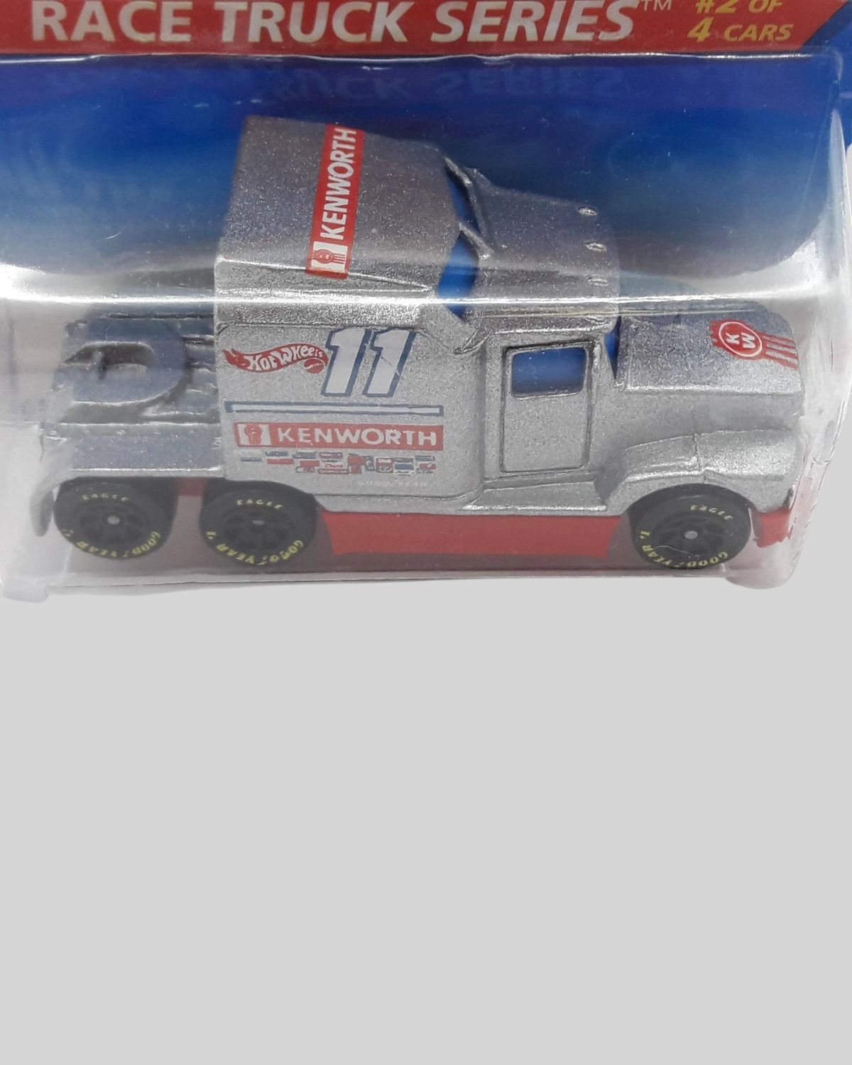 More Than Diecast Hot Wheels Ford LTL Kenworth T600 race truck in silver and red with number 11 on blister card