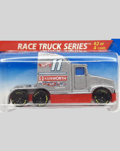 More Than Diecast Hot Wheels Ford LTL Kenworth T600 race truck in silver and red on a blister card with protector