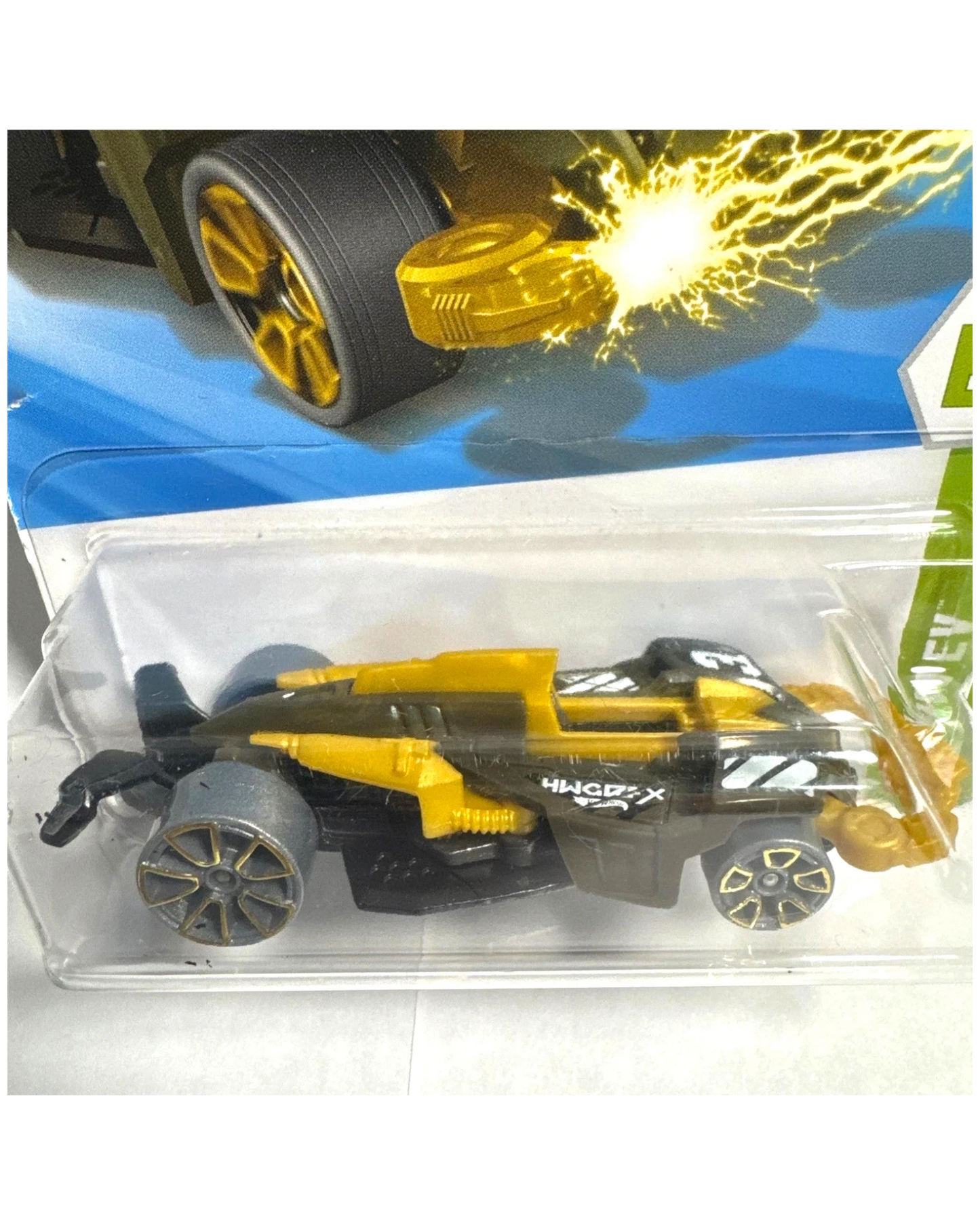 More Than Diecast Hot Wheels Wattzup 1:64 scale die-cast car in green and gold with black accents and tampo print detailing. Packaged.