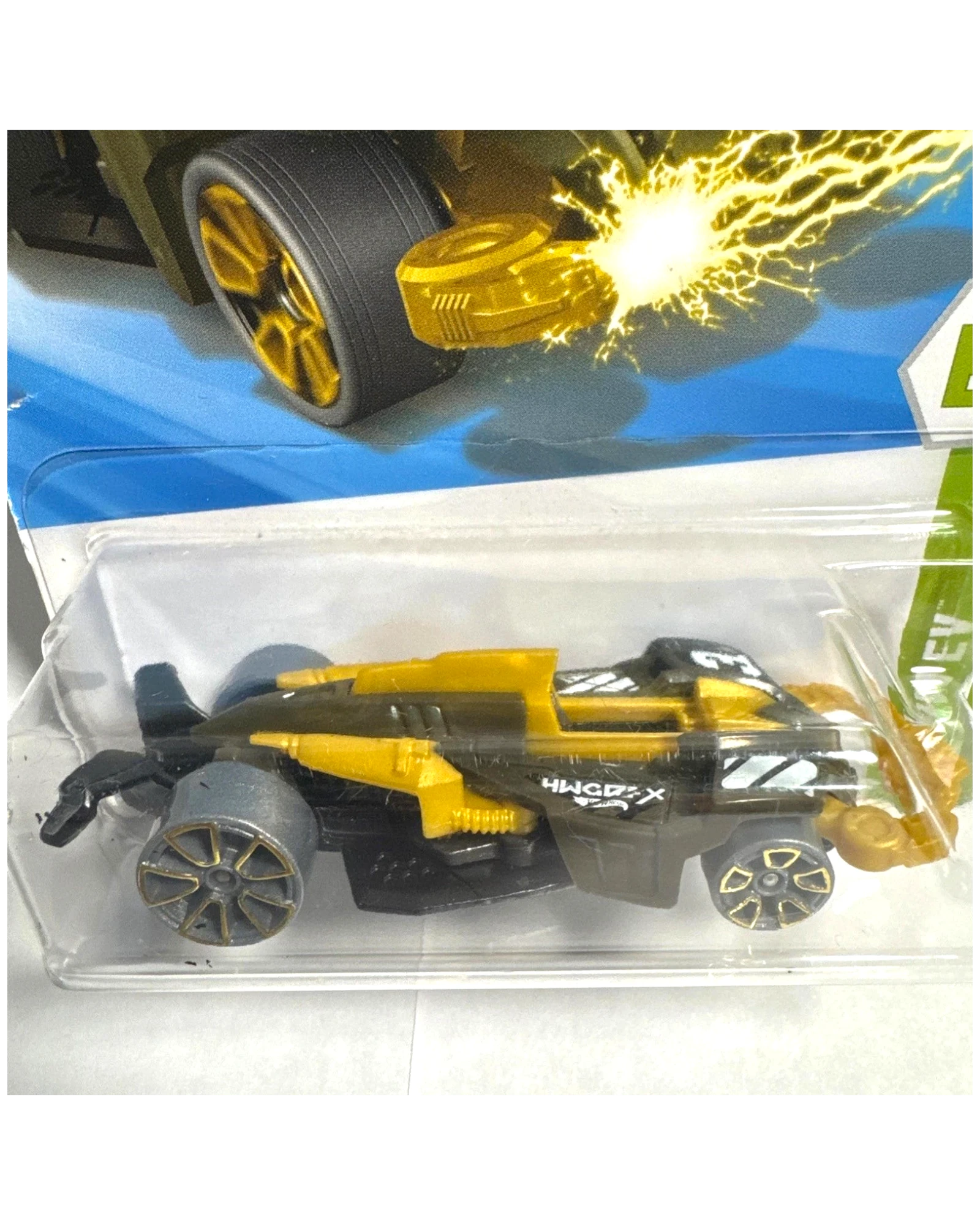 More Than Diecast Hot Wheels Wattzup 1:64 scale die-cast car in green and gold with black accents and tampo print detailing. Packaged.