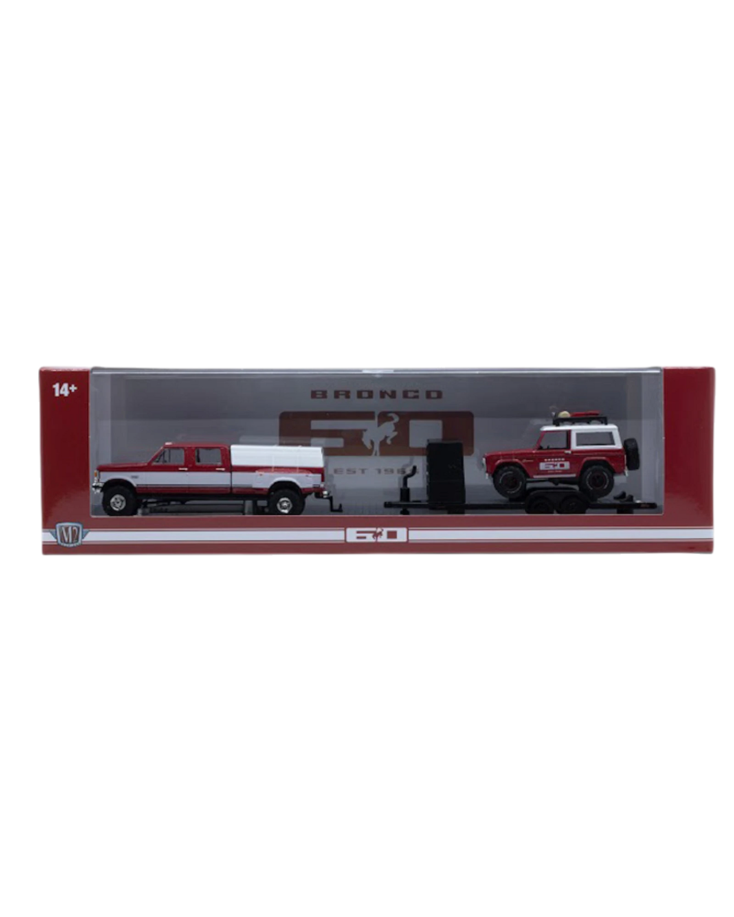 More Than Diecast M2 Machines 1:64 scale red and white Ford truck hauling a Bronco on a trailer in display packaging.