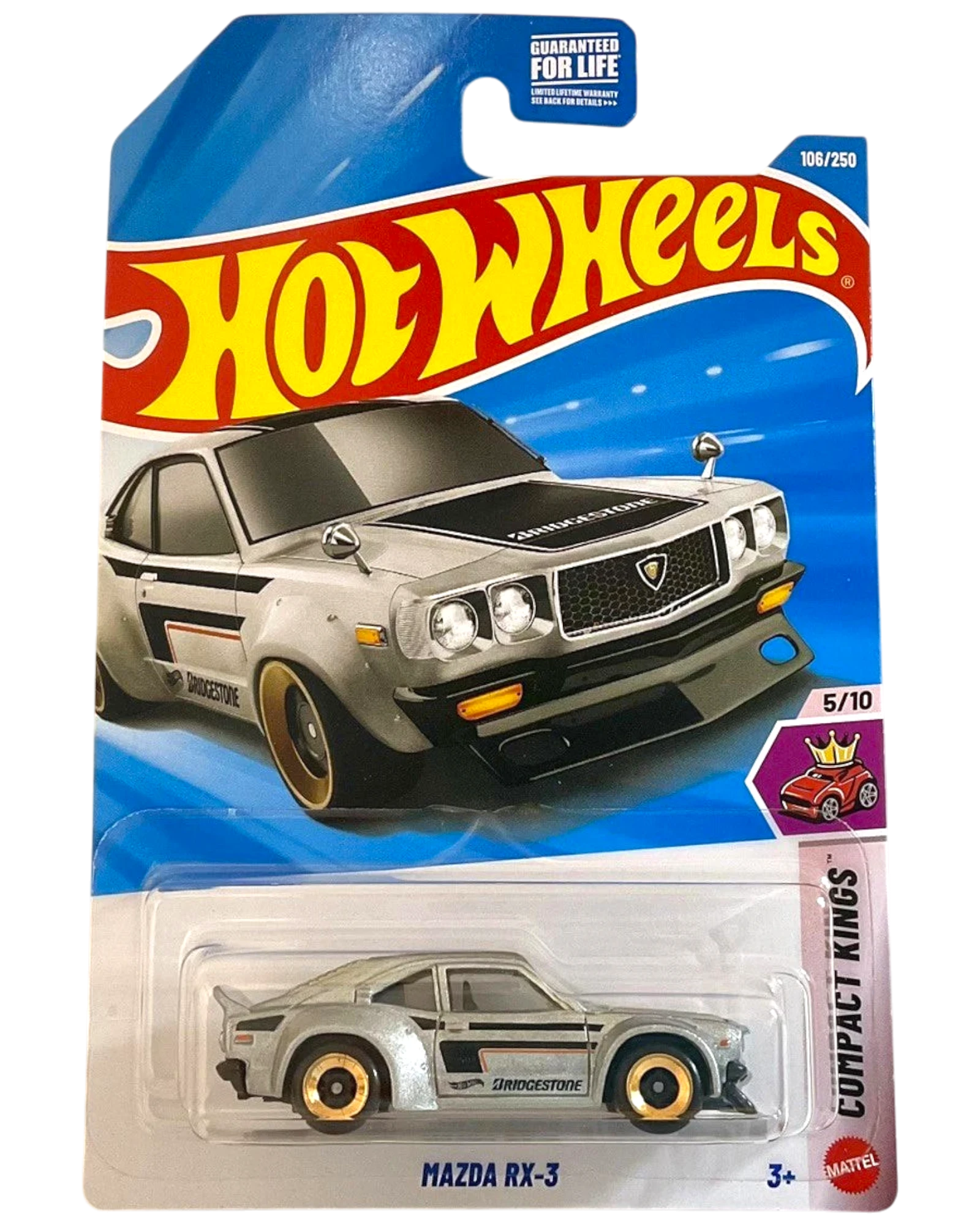 More Than Diecast 2026 Hot Wheels Mazda RX-3 diecast car, silver with black racing stripes and gold rims.