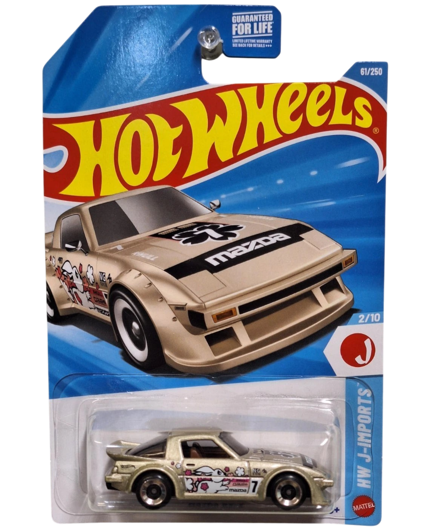 More Than Diecast Hot Wheels 2026 Mazda RX-7 die-cast car in gold with J-Imports graphics on blister card packaging.