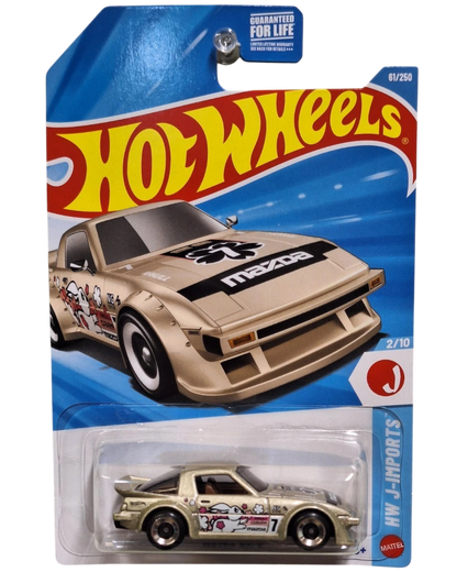 More Than Diecast Hot Wheels 2026 Mazda RX-7 die-cast car in gold with J-Imports graphics on blister card packaging.