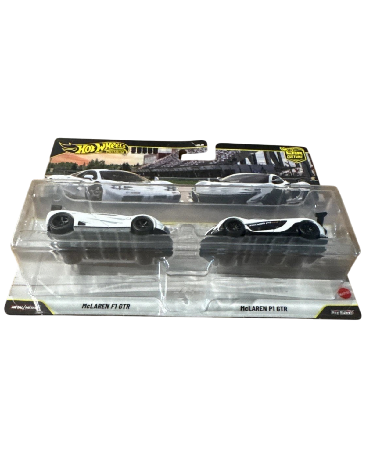 More Than Diecast Hot Wheels Premium 2-pack featuring white McLaren F1 GTR and P1 GTR diecast race cars in packaging.