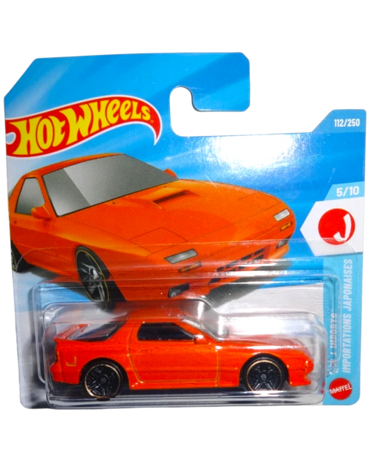 More Than Diecast: Orange 1989 Mazda Savanna RX-7 FC3S Hot Wheels toy car in packaging.