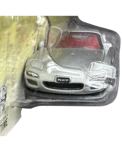 More Than Diecast silver 2002 Mazda RX-7 Spirit R die-cast car in blister packaging with red interior detail