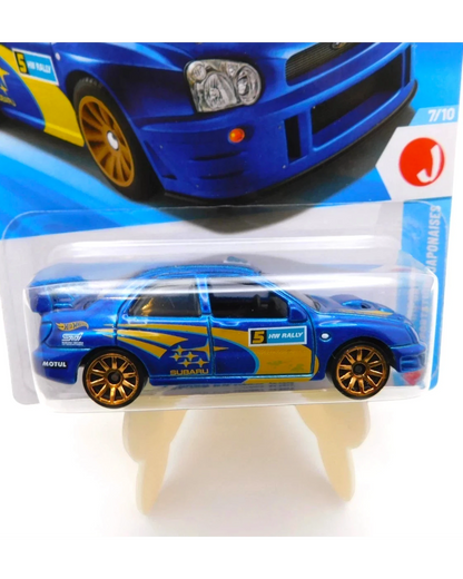 More Than Diecast Hot Wheels 2002 Subaru Impreza WRX in blue with gold wheels and rally graphics on blister card