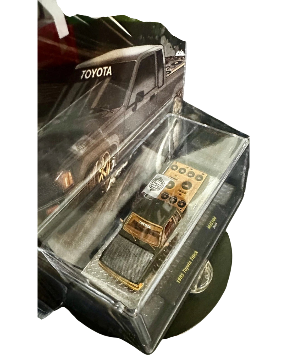 More Than Diecast 1:64 scale M2 Machines 1985 Toyota Pickup Truck chase variant in matte grey with a slammed stance.