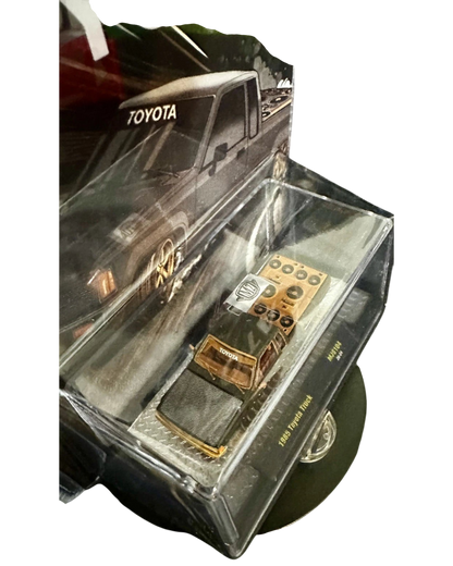 More Than Diecast 1:64 scale M2 Machines 1985 Toyota Pickup Truck chase variant in matte grey with a slammed stance.
