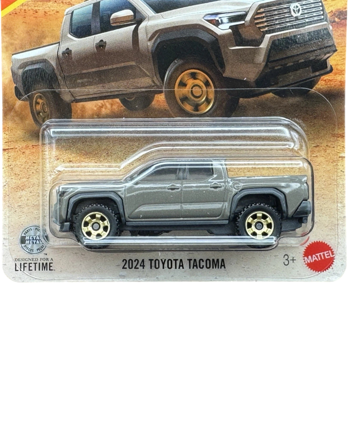 More Than Diecast 1:64 scale 2024 Toyota Tacoma die-cast truck in brown, packaged on a desert-themed card.
