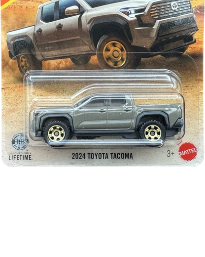 More Than Diecast 1:64 scale 2024 Toyota Tacoma die-cast truck in brown, packaged on a desert-themed card.