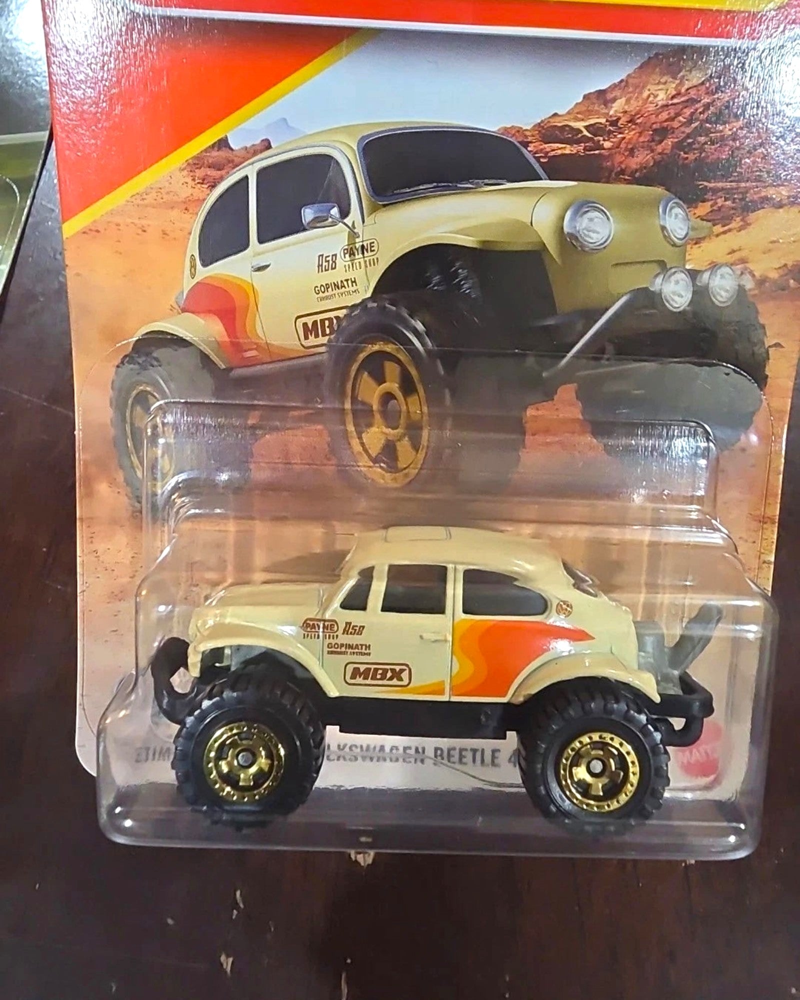 More Than Diecast 2026 Matchbox Volkswagen Beetle 4x4 diecast car in tan with off-road tires and racing decals