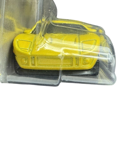 More Than Diecast 1:64 scale 2005 Ford GT die-cast car in bright yellow, front view in original blister packaging.